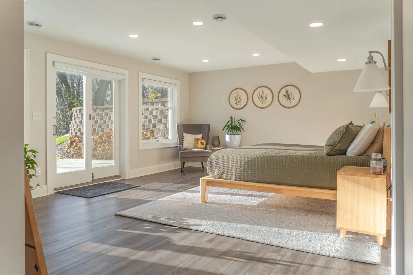 Finished lower level with a bedroom, patio doors, and wide plank flooring
